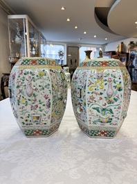 A pair of Chinese famille rose 'Antiquities' vases and covers, 19th C.