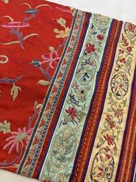 A Chinese embroidered silk red-ground women's robe, 19th C.