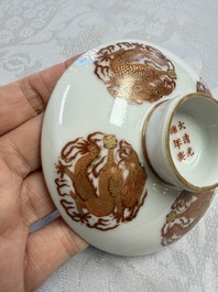 A fine Chinese iron-red gilt-decorated covered teabowl with a stand, Guangxu mark and of the period