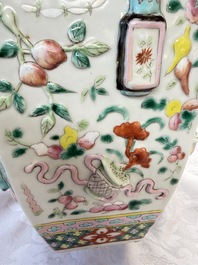 A pair of Chinese famille rose 'Antiquities' vases and covers, 19th C.