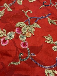 A Chinese embroidered silk red-ground women's robe, 19th C.