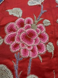 A Chinese embroidered silk red-ground women's robe, 19th C.