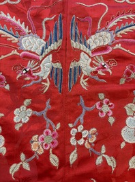 A Chinese embroidered silk red-ground women's robe, 19th C.