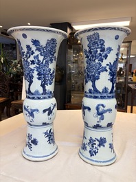 A pair of large Chinese blue and white 'Gu' vases with elegant ladies and playing boys, Kangxi