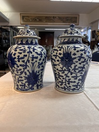 Two Chinese blue and white 'Lotus Scroll' vases and covers, Kangxi