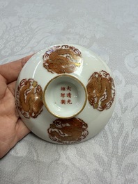 A fine Chinese iron-red gilt-decorated covered teabowl with a stand, Guangxu mark and of the period