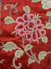 A Chinese embroidered silk red-ground women's robe, 19th C.