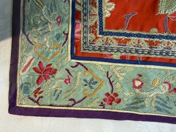 A Chinese embroidered silk red-ground women's robe, 19th C.