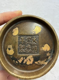 A Chinese gold-splashed bronze censer with two handles, Xuande mark, 18th C.