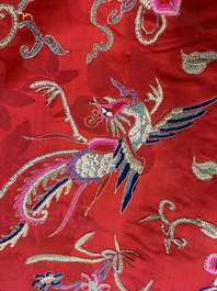 A Chinese embroidered silk red-ground women's robe, 19th C.
