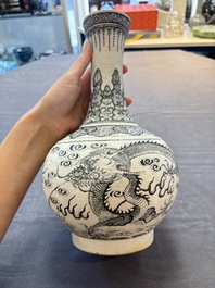 A Chinese black-enamelled biscuit 'Dragon' vase, Kangxi mark, 19th C.
