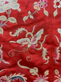 A Chinese embroidered silk red-ground women's robe, 19th C.