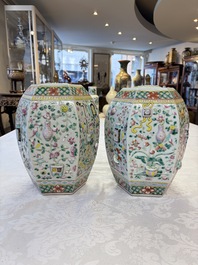 A pair of Chinese famille rose 'Antiquities' vases and covers, 19th C.