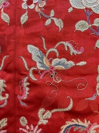 A Chinese embroidered silk red-ground women's robe, 19th C.