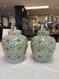 A rare pair of Chinese famille verte yellow-ground 'Flower Scroll' covered vases, Kangxi