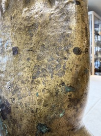 A rare and large Tibetan bronze forearm of a Buddhist figure with a chakra design, on a later metal stand, Qing