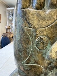 A rare and large Tibetan bronze forearm of a Buddhist figure with a chakra design, on a later metal stand, Qing