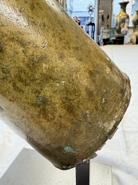 A rare and large Tibetan bronze forearm of a Buddhist figure with a chakra design, on a later metal stand, Qing