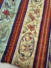 A Chinese embroidered silk red-ground women's robe, 19th C.