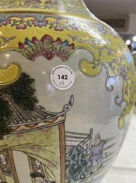 A pair of large Chinese famille rose yellow-ground 'Hu' vases with narrative design, Qianlong mark, Republic