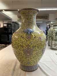 A pair of large Chinese famille rose yellow-ground 'Hu' vases with narrative design, Qianlong mark, Republic
