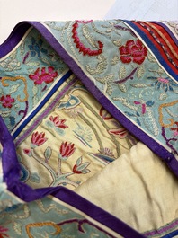 A Chinese embroidered silk red-ground women's robe, 19th C.