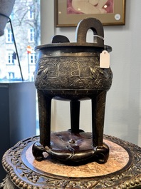 A rare Chinese gold- and silver-inlaid bronze 'Ding' censer with Taotie design on a hongmu stand, Shaosheng 紹聖 and Su Zhe 蘇轍 mark, Song or later