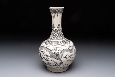 A Chinese black-enamelled biscuit 'Dragon' vase, Kangxi mark, 19th C.