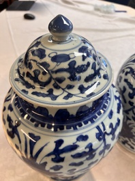 Two Chinese blue and white 'Lotus Scroll' vases and covers, Kangxi