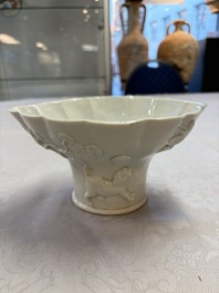 A very large Chinese Dehua blanc de Chine libation cup with a dragon, a qilin, a tiger and a crane, 18th C.