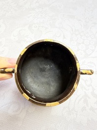 A Chinese gold-splashed bronze censer with two handles, Xuande mark, 18th C.