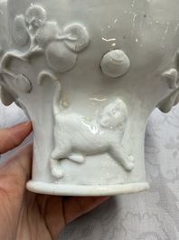A very large Chinese Dehua blanc de Chine libation cup with a dragon, a qilin, a tiger and a crane, 18th C.