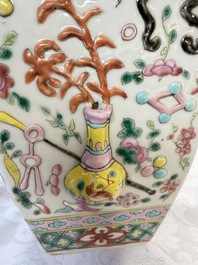 A pair of Chinese famille rose 'Antiquities' vases and covers, 19th C.
