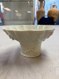 A very large Chinese Dehua blanc de Chine libation cup with a dragon, a qilin, a tiger and a crane, 18th C.