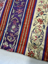 A Chinese embroidered silk red-ground women's robe, 19th C.