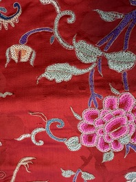 A Chinese embroidered silk red-ground women's robe, 19th C.