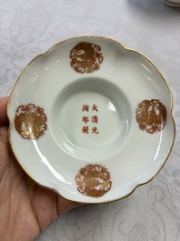 A fine Chinese iron-red gilt-decorated covered teabowl with a stand, Guangxu mark and of the period