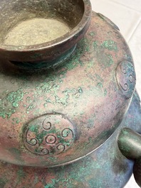 A large Chinese archaistic bronze wine vessel and cover with ram-form handles, Lei 罍, Ming
