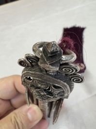 A fine Chinese silver pendant with inscriptions on a plexiglas stand, 19th C.