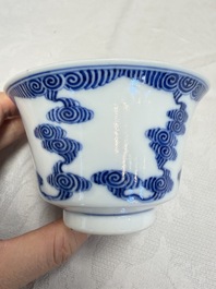 A pair of Chinese inscribed blue and white 'Clouds' tea bowls, covers and stands, Guangxu mark and of the period