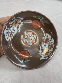 A Chinese famille rose capucine-ground covered teapot with floral design, seven cups and saucers, Yongzheng/Qianlong