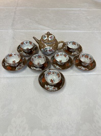 A Chinese famille rose capucine-ground covered teapot with floral design, seven cups and saucers, Yongzheng/Qianlong
