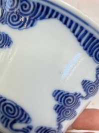 A pair of Chinese inscribed blue and white 'Clouds' tea bowls, covers and stands, Guangxu mark and of the period