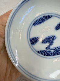 A pair of Chinese inscribed blue and white 'Clouds' tea bowls, covers and stands, Guangxu mark and of the period
