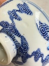 A pair of Chinese inscribed blue and white 'Clouds' tea bowls, covers and stands, Guangxu mark and of the period