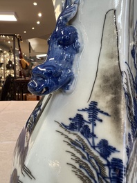 A Chinese blue, white and copper-red 'Hu' vase with figures in a mountainous landscape, 19th C.