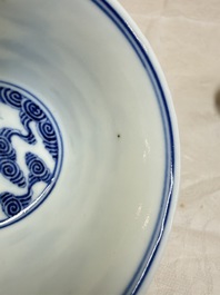 A pair of Chinese inscribed blue and white 'Clouds' tea bowls, covers and stands, Guangxu mark and of the period