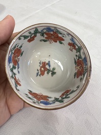 A Chinese famille rose capucine-ground covered teapot with floral design, seven cups and saucers, Yongzheng/Qianlong
