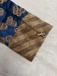 A Chinese embroidered silk blue-ground 'Dragons' robe, adapted into a lady's dress, 19th C. and later