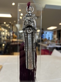 A fine Chinese silver pendant with inscriptions on a plexiglas stand, 19th C.